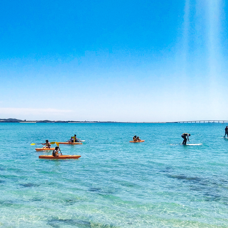 Individuals enjoying kayaking and surfing in the breathtaking ocean at Point Peron Camp Fairbridge