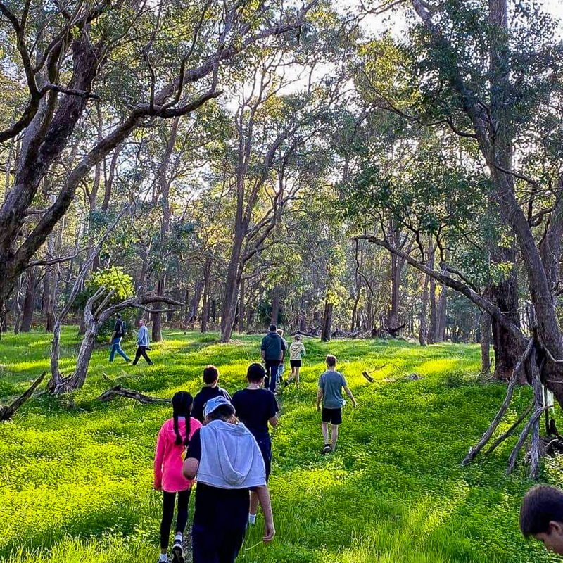 A group of people enjoys bushwalking as part of the outdoor education program at Camp Fairbridge