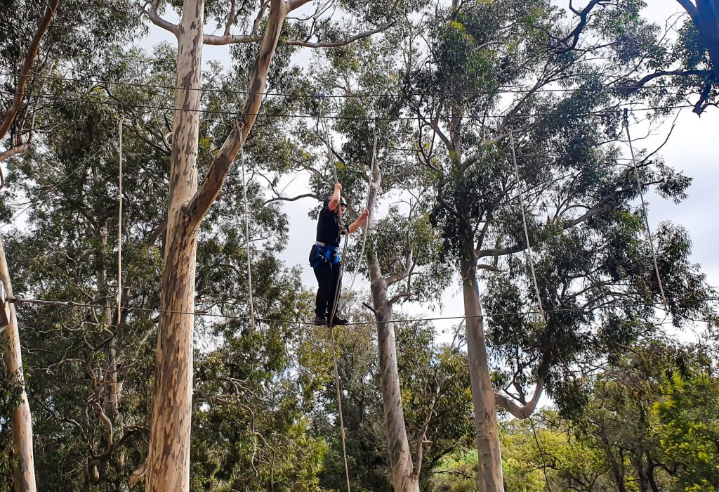 An indivdual enjoying high ropes obstacle course activity at Camp Fairbridge An indivdual enjoying high ropes obstacle course activity at Camp Fairbridge